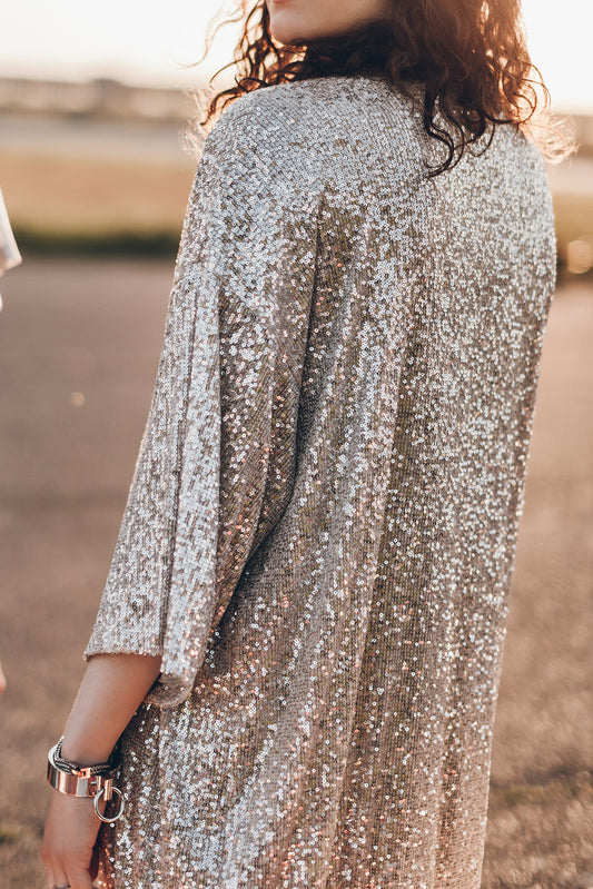 A glam golden  3/4 length kimono with an open front and a beautiful sequin design - perfect for adding some sparkle to your outfit.