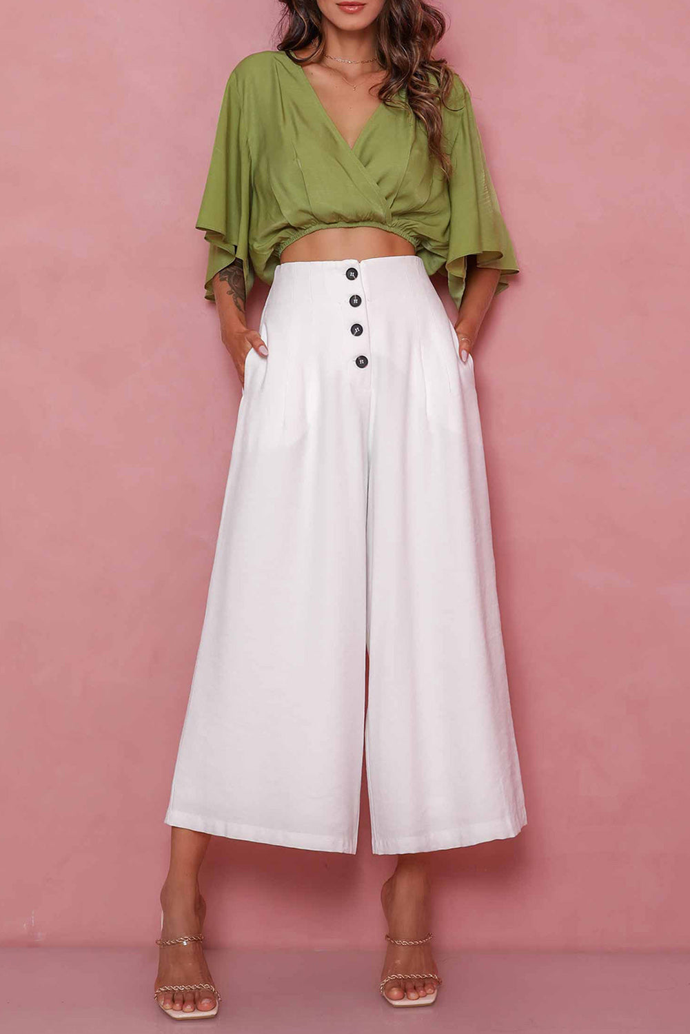 A pair of white cropped wide leg pants with button detailing - perfect for a smart casual look.