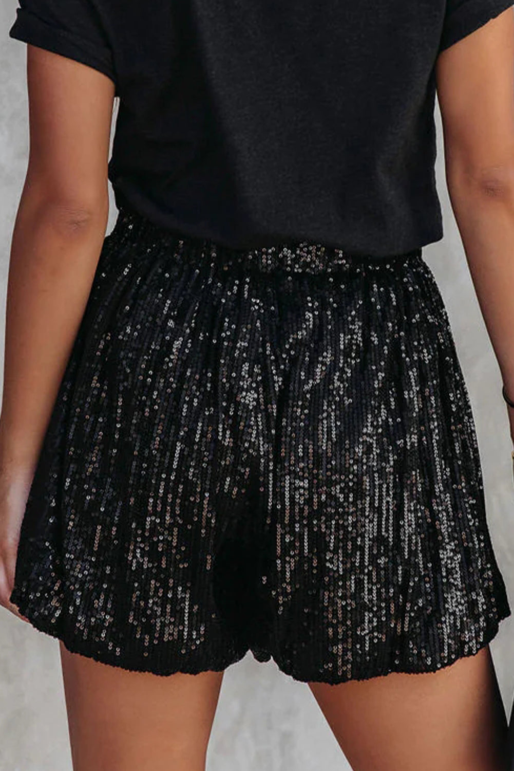 A black sequined, high-waisted shorts with a straight leg that brings a stylish and comfy look to any casual or more dress-up event.