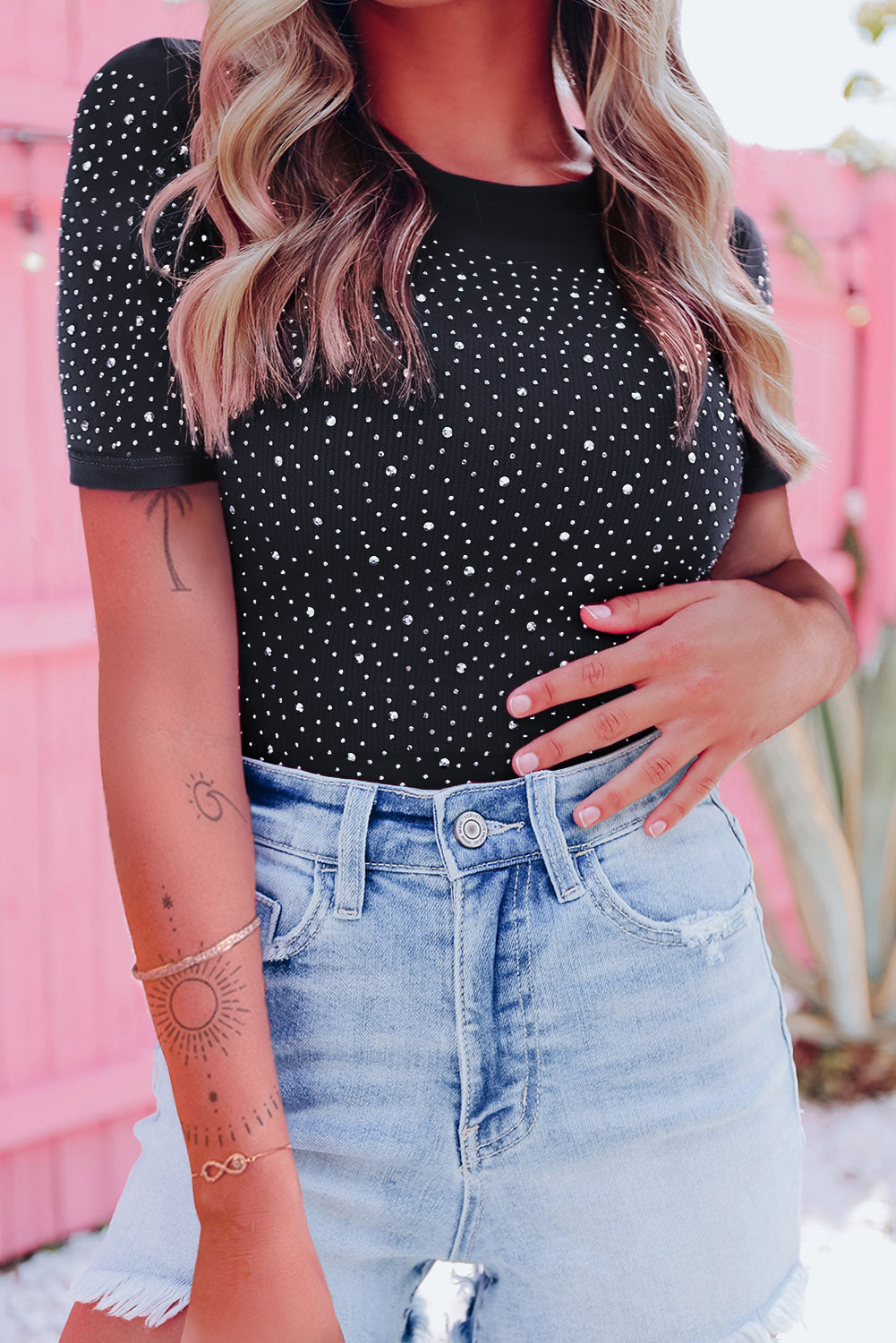 Sparkle and shine in this gorgeous black rhinestone bodysuit, featuring an allover round neck and short sleeves.