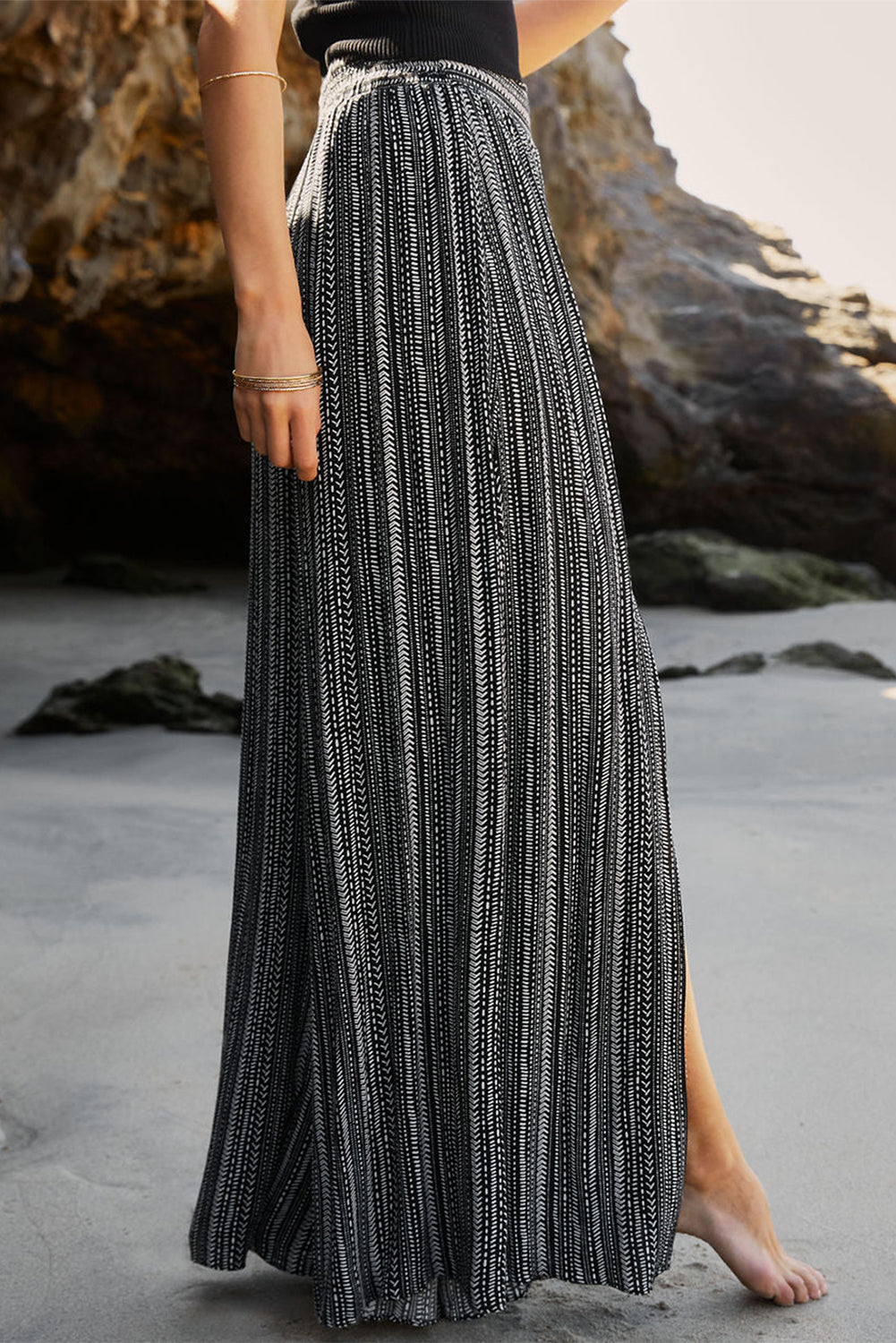 Flattering and flowy loose pants with front slit detail and a playful mix of stripes.