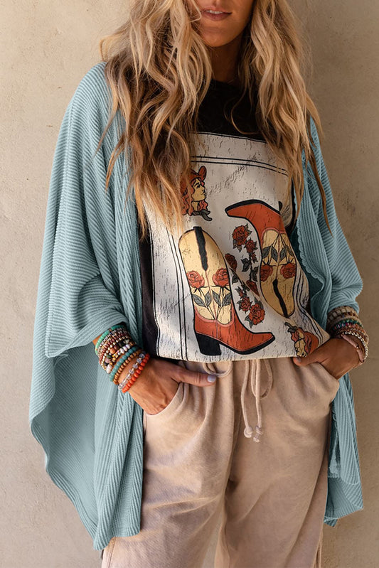 A sky blue, oversize kimono with lace trim and a ribbed texture.