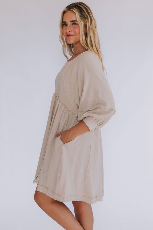 Loose-fitting dress with 3/4 sleeves, high waist, and slits.