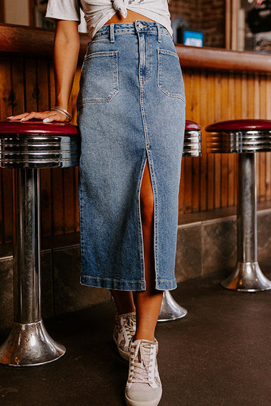 A chic front slit midi length denim skirt in blue, featuring a high-waist design and four practical patch pockets. 