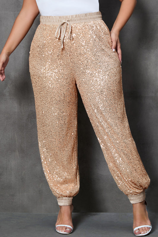 Plus-size sequin jogger pants with adjustable drawstring waist and cinched cuffs, perfect for standing out at any special event or night out.