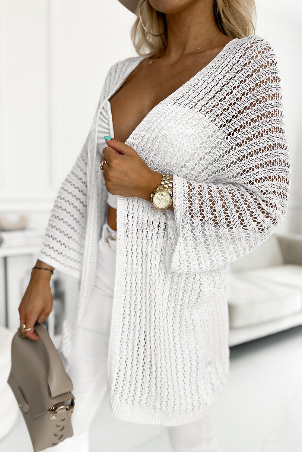 White, open-knit kimono-style cardigan featuring a gentle pattern of hollow-out detail.