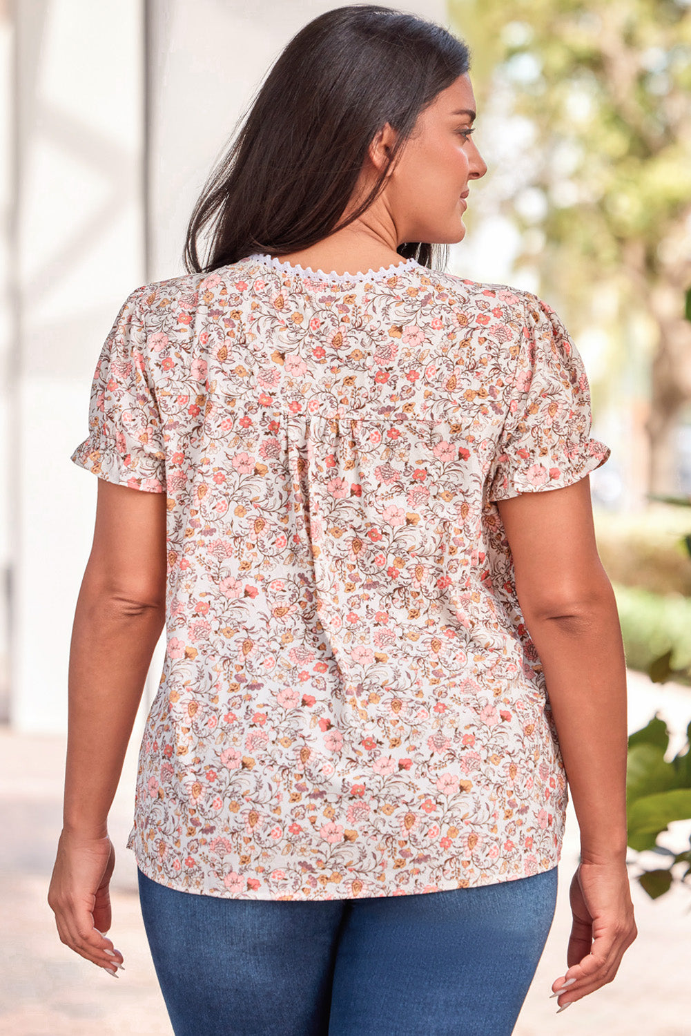 A pink lace trim split-neck top with a beautiful floral pattern, perfect for summer and plus-sized silhouettes.