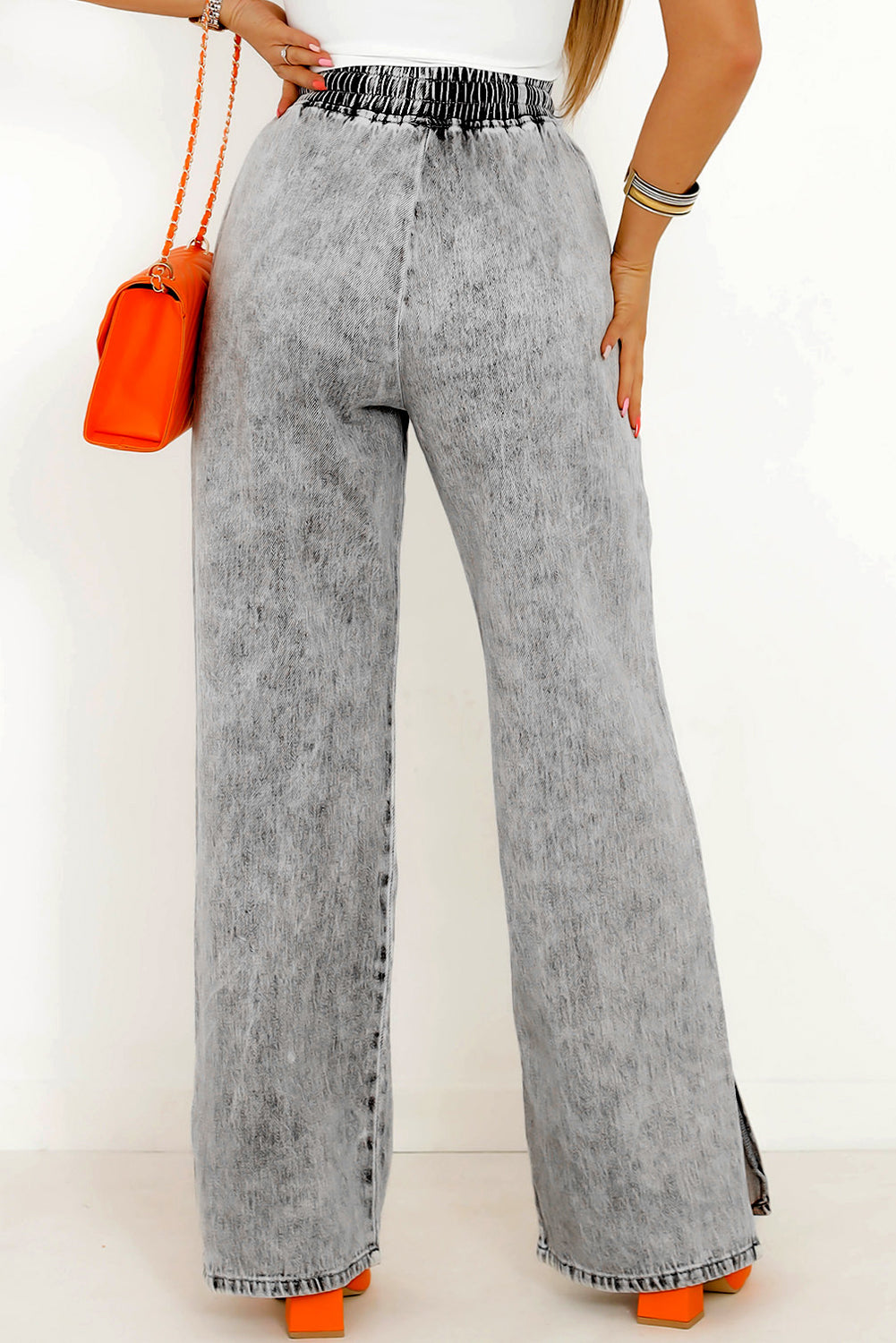 A stylish pair of grey drawstring waist denim pants from a cotton blend fabric, designed with a wide leg for a relaxed yet flattering fit. Perfect for laid-back days!