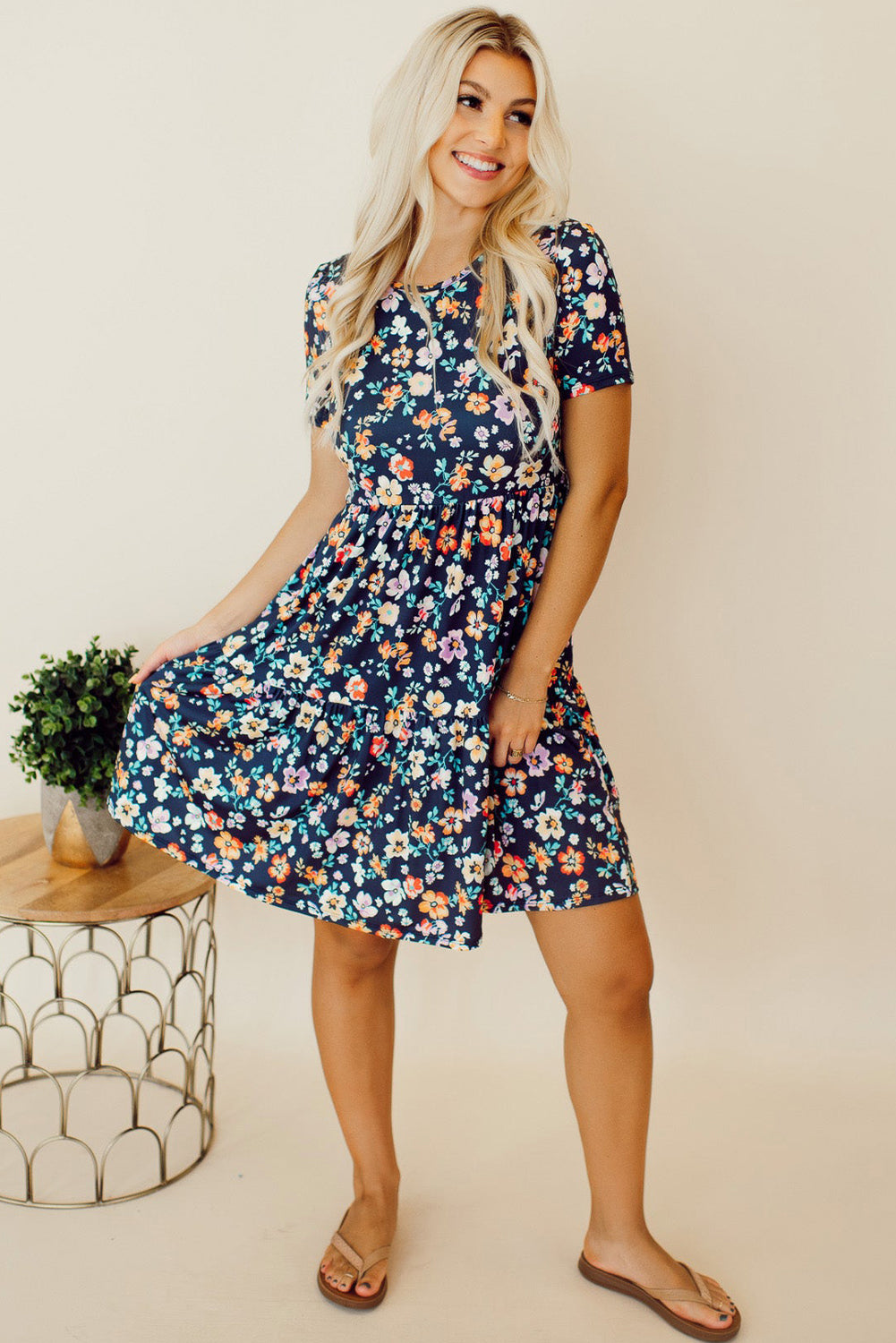 Floral printed short dress with round neck and ruffle skirt.