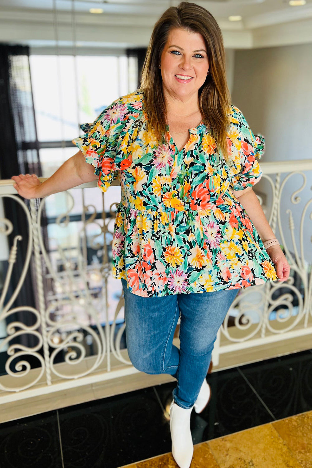 Brighten up your wardrobe with this plus size multicoloured floral ruffled blouse, perfect for warmer days.