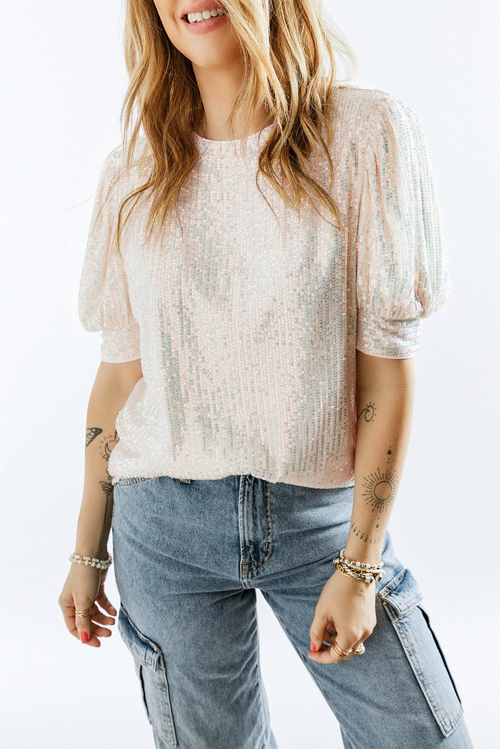 Add sparkle and style to your wardrobe with the Sequin Puff Sleeve Top! This top features glimmering sequin sleeves and a soft body fabric for a comfortable and fashionable ensemble when worn with your favourite jeans.