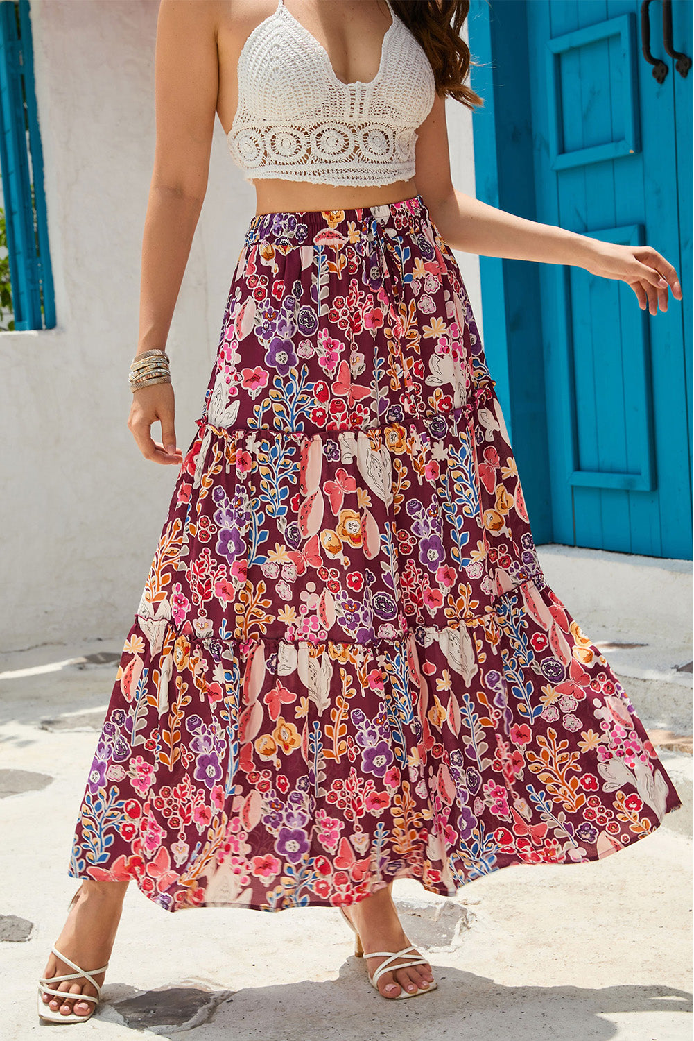 A multicolored boho-style maxi skirt with a bold floral print and a high waist for a flattering shape.