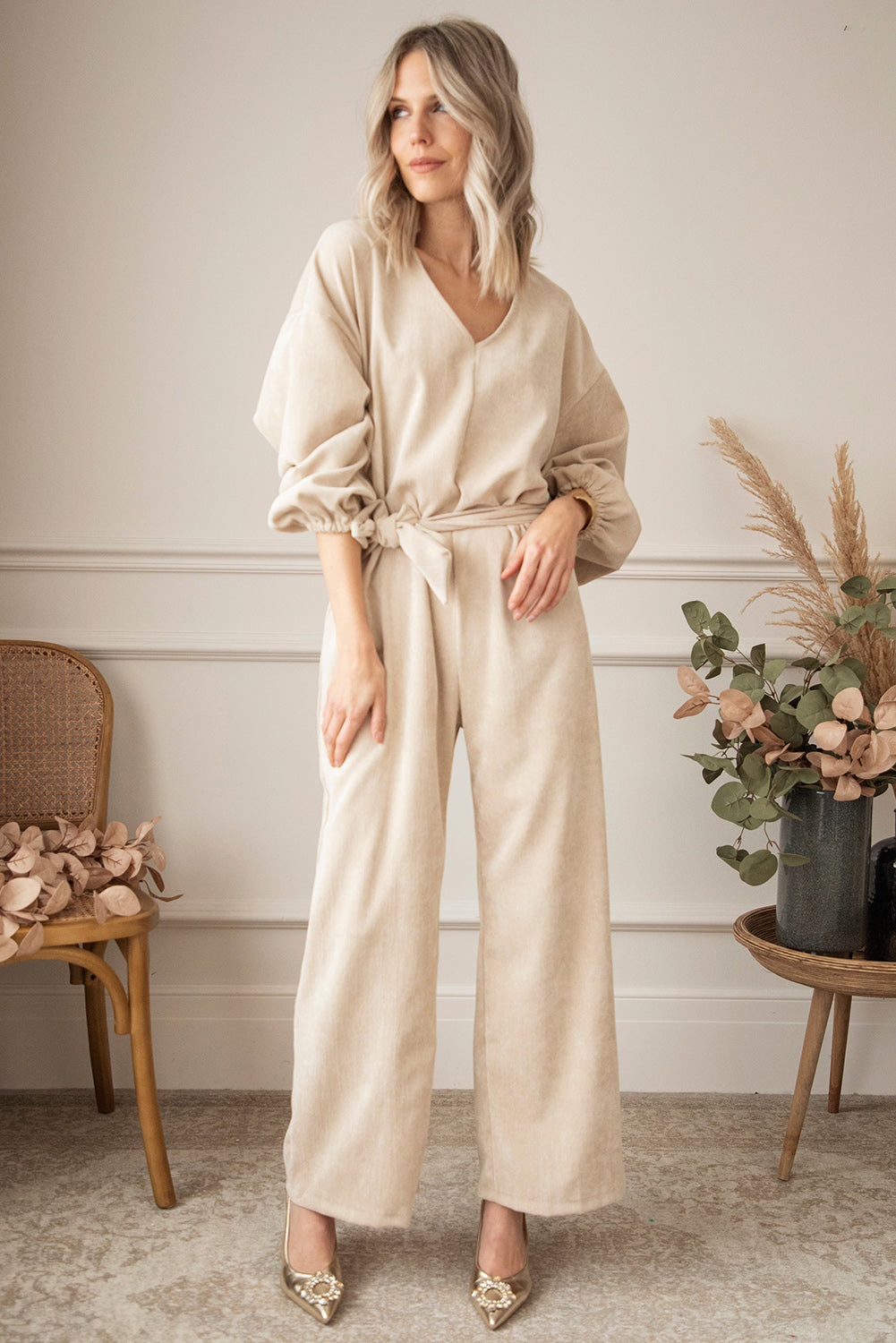   Keyhole Back V Neck Tie Waist Loose Jumpsuit featuring a v-neckline, puff sleeves, a sash tie at the waist, and wide-leg bottoms.