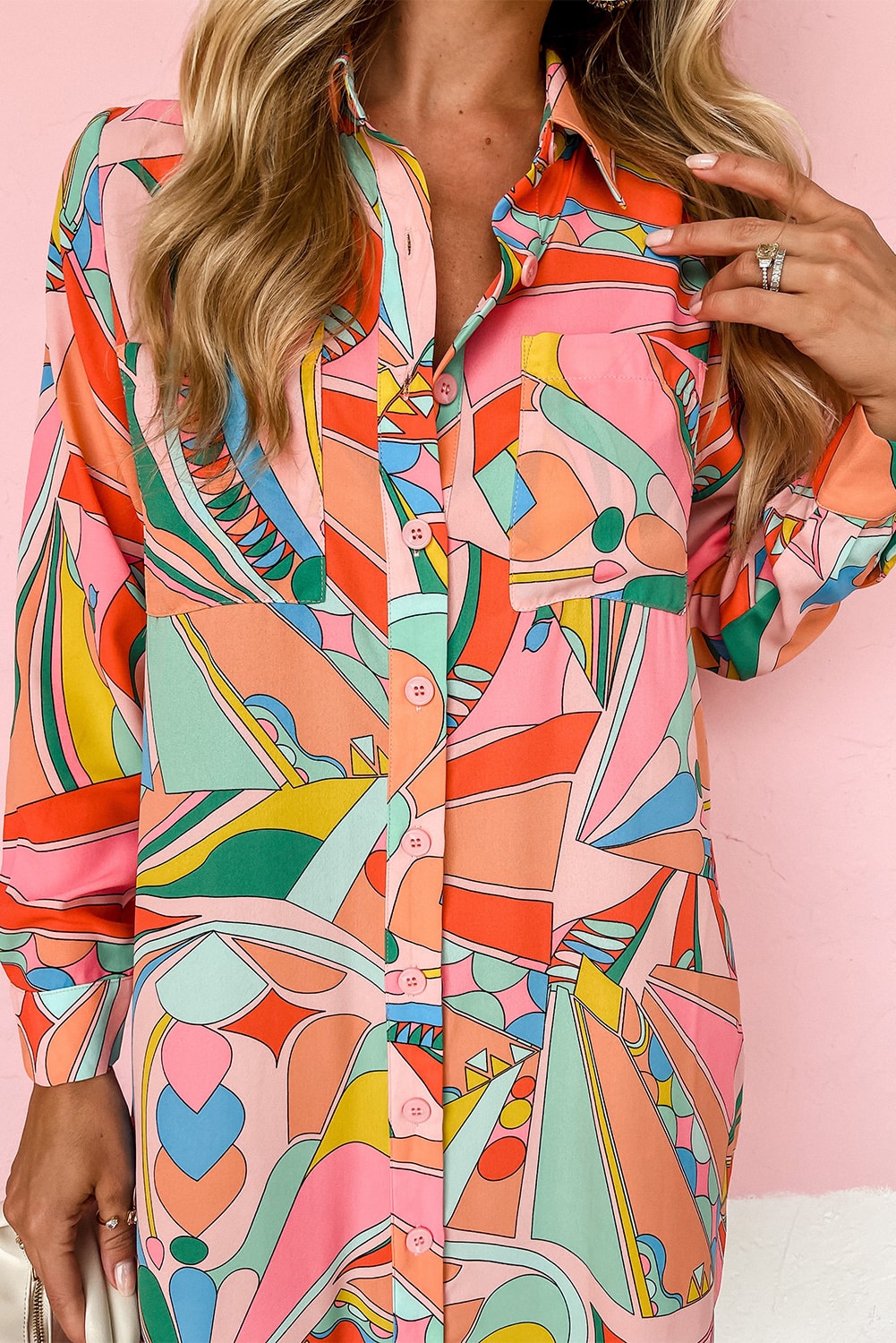 A long sleeve abstract print shirt dress in a variety of bright colors, featuring geometric shapes and patterns.