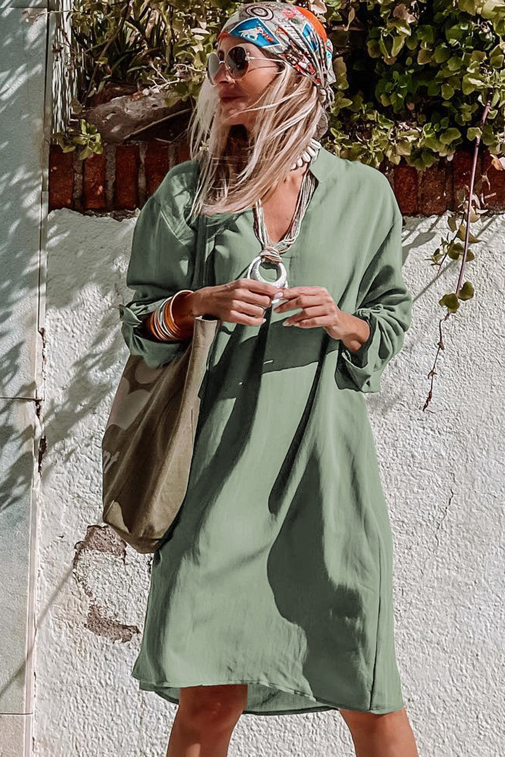 A femme green dress with flattering rolled sleeve detail, perfect for any laid-back day or night look.