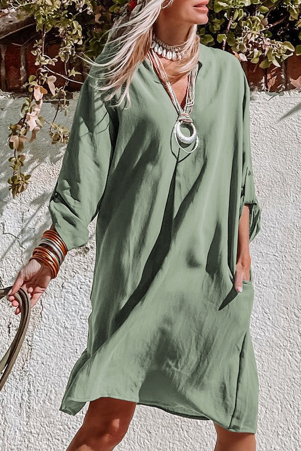 A femme green dress with flattering rolled sleeve detail, perfect for any laid-back day or night look.