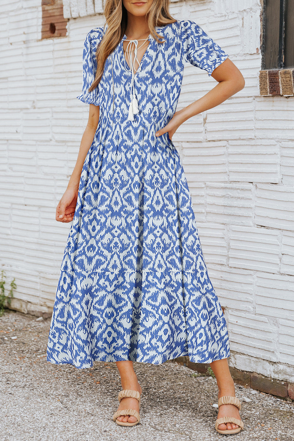 A sky blue V-neck dress with a geometric pattern, perfect for a casual summer maxi-dress look