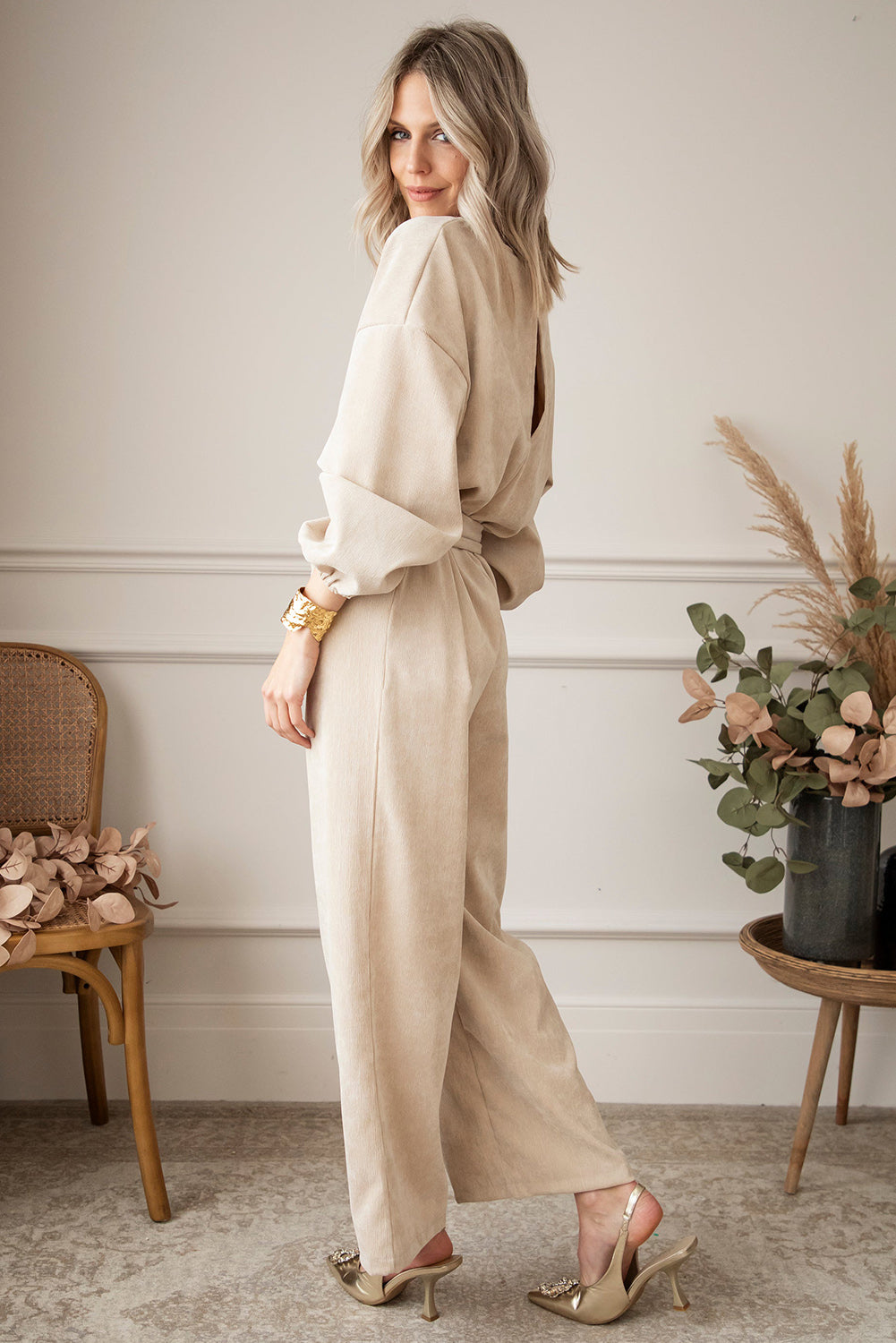   Keyhole Back V Neck Tie Waist Loose Jumpsuit featuring a v-neckline, puff sleeves, a sash tie at the waist, and wide-leg bottoms.