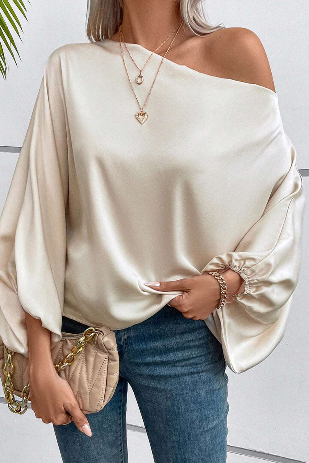 Shiny Asymmetrical Neck Blouse with Balloon Sleeves made of soft and glossy satin fabric.