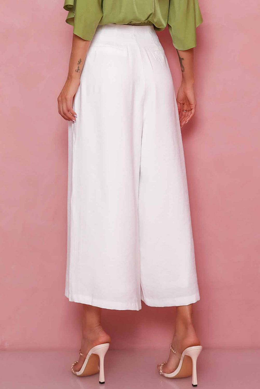 A pair of white cropped wide leg pants with button detailing - perfect for a smart casual look.