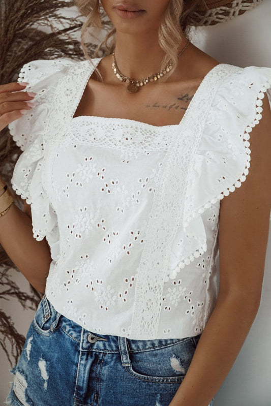 A white square neck blouse with delicate ruffled sleeves, featuring a floral eyelet lace pattern. An elegant and versatile piece, perfect for any summer look.