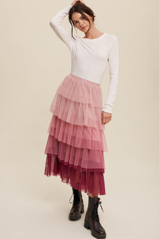 A bright pink, ruffled mesh skirt perfect for adding a touch of femininity to any outfit!