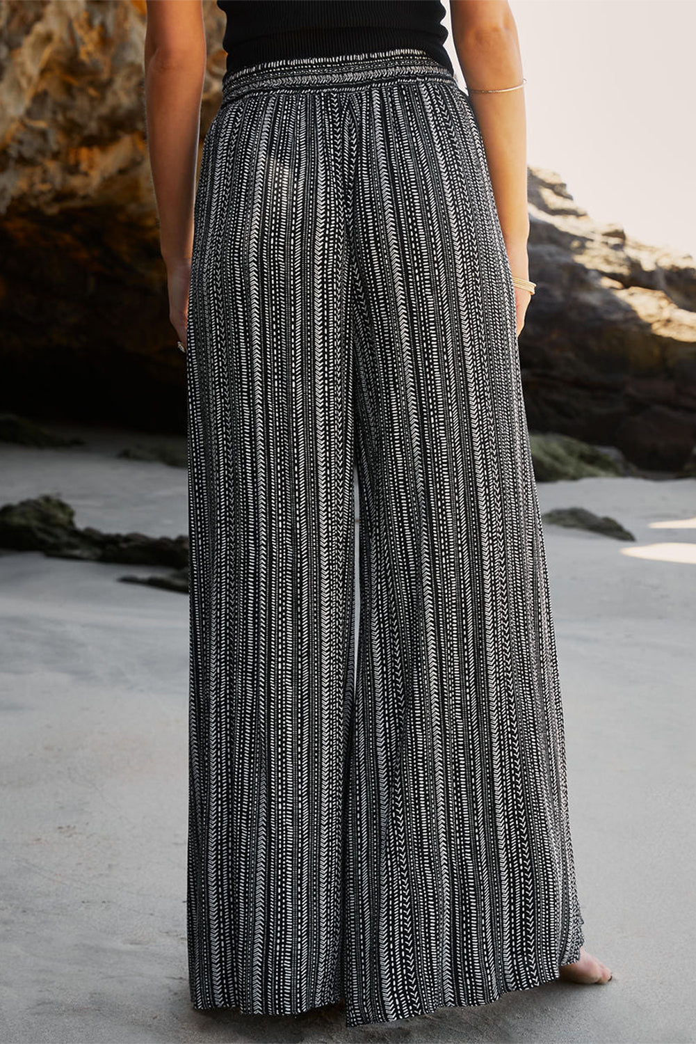 Flattering and flowy loose pants with front slit detail and a playful mix of stripes.