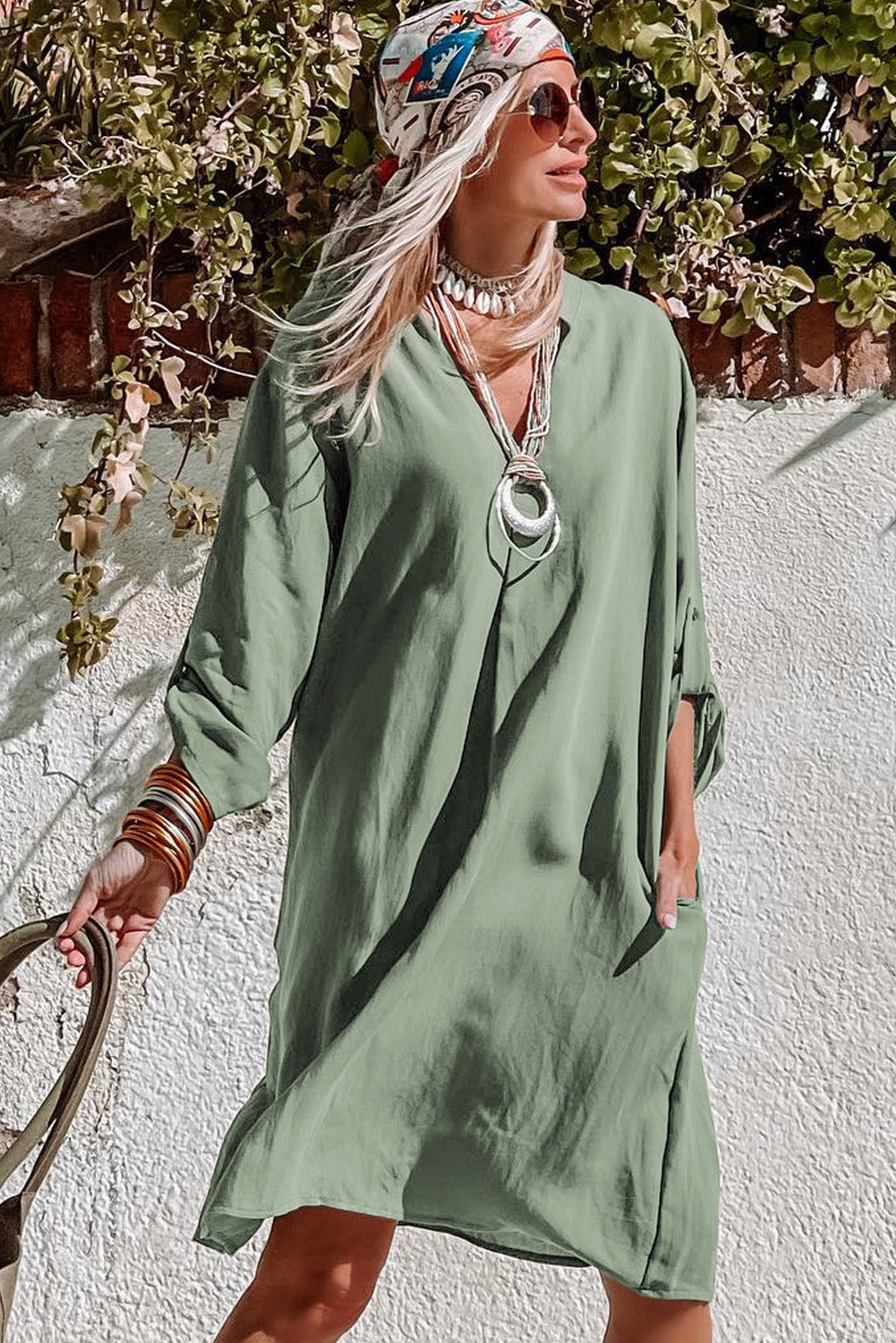 A femme green dress with flattering rolled sleeve detail, perfect for any laid-back day or night look.